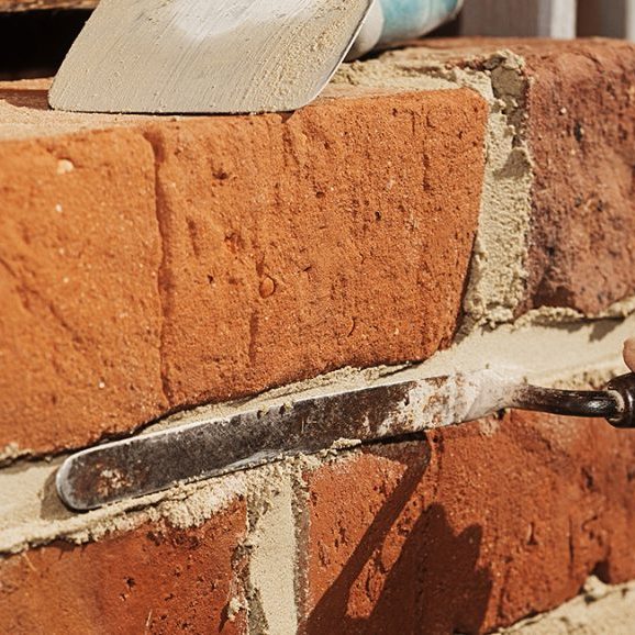 mason laying bricks